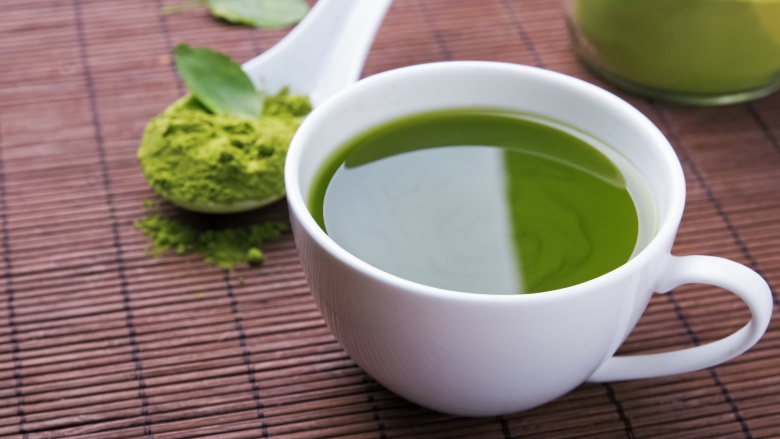 A Cup of Green Tea Placed On The Table.