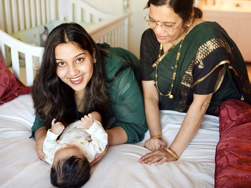 A Woman With Her Kid In Home.