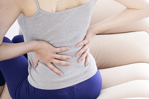 A Woman Suffering From Lower back pain.