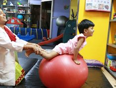 Kid Exercising In Physiotherapy Session.