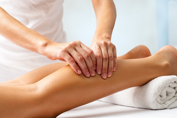 A Physiotherapist Work With Woman Legs.