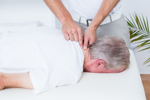 A Therapist Senses The Pain Nerve In A Senior Citizen's Neck.