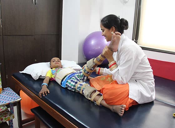 A Therapist Working With A Kid In Her Clinic.